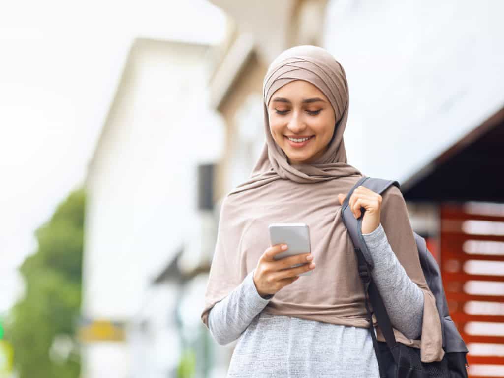 Own Homes image of woman looking at mobile phone