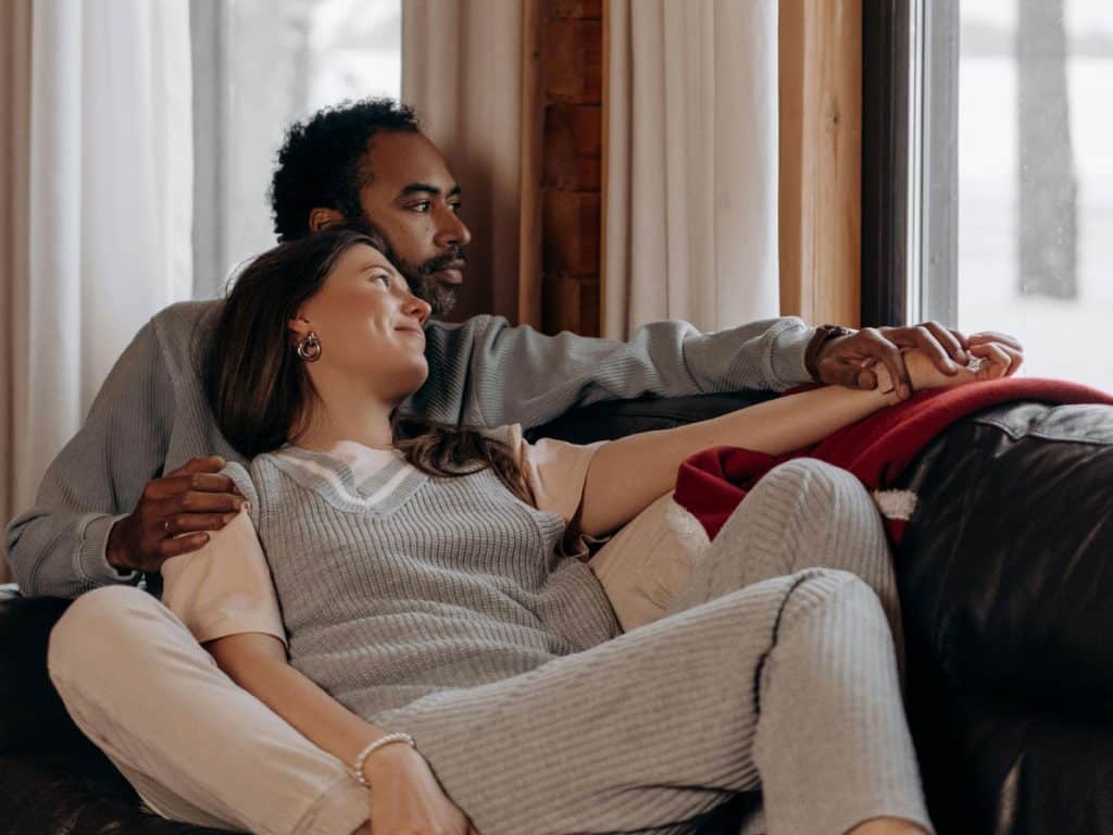 Own Homes image of couple relaxing on sofa in their home