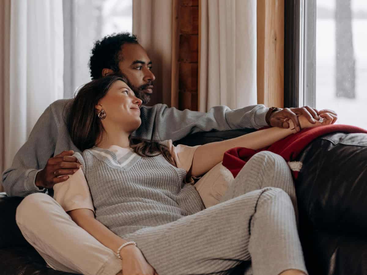 Own Homes image of couple relaxing on sofa in their home